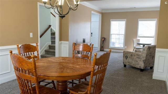 carpeted dining area with crown molding and a chandelier