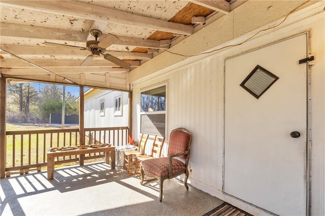 sunroom / solarium featuring ceiling fan