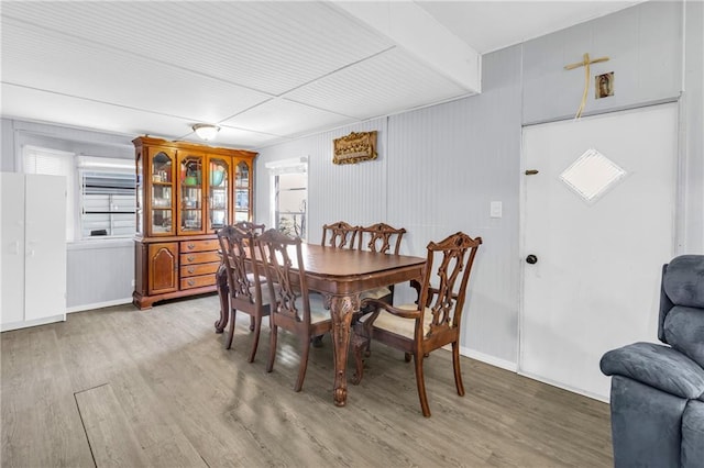 dining room with baseboards and light wood-style floors