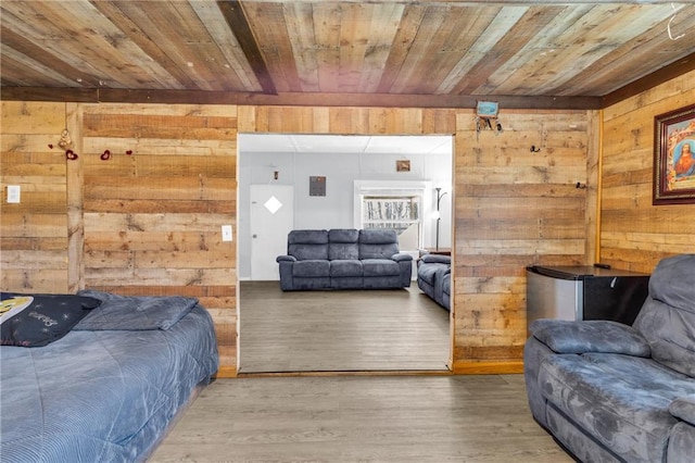 interior space featuring wooden walls, wooden ceiling, and wood finished floors