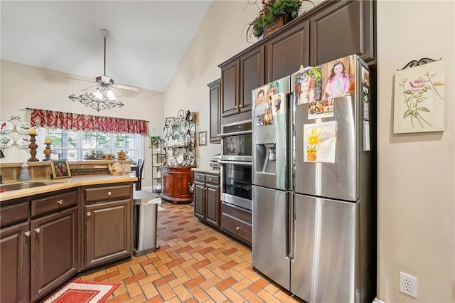 kitchen with a sink, stainless steel appliances, dark brown cabinets, and light countertops