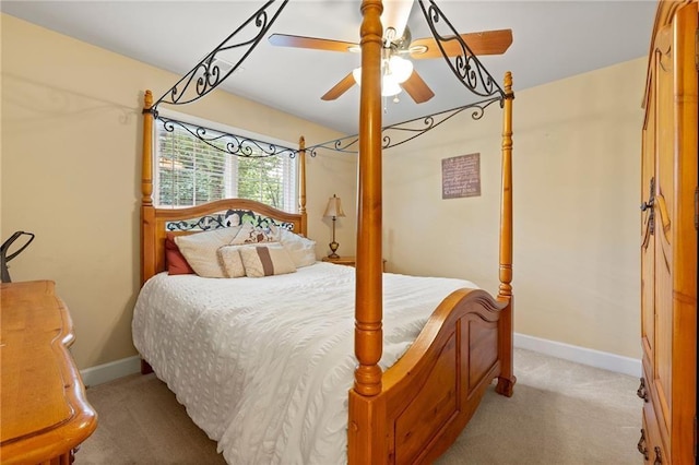 bedroom featuring light carpet, ceiling fan, and baseboards