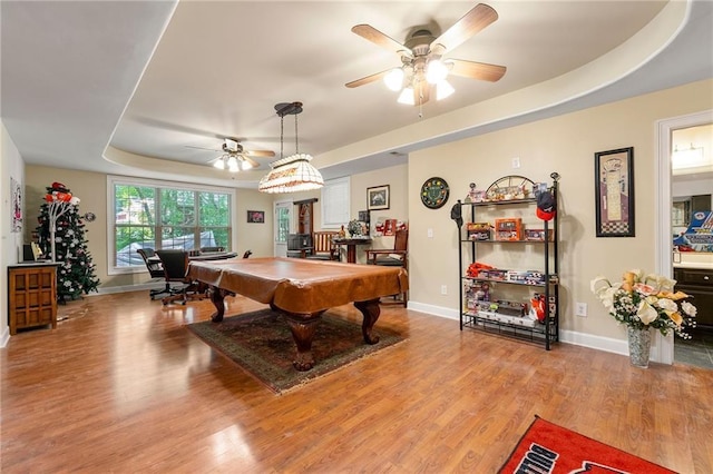 playroom with a tray ceiling, ceiling fan, light wood-type flooring, billiards, and baseboards