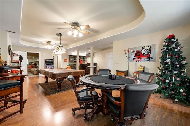 recreation room featuring ceiling fan, billiards, visible vents, light wood-style floors, and a tray ceiling