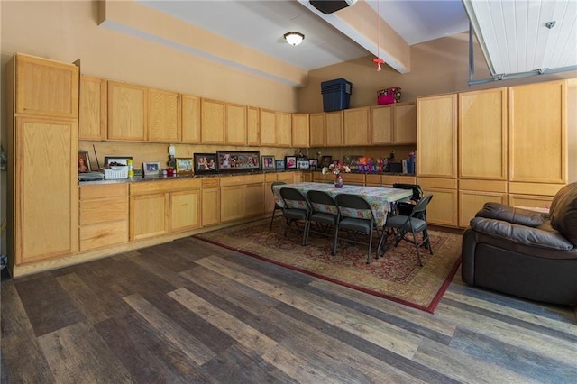 kitchen with dark wood-style flooring, a high ceiling, beamed ceiling, and light brown cabinets