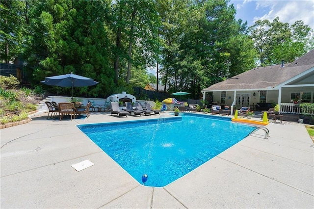 view of swimming pool featuring a patio, fence, and a fenced in pool