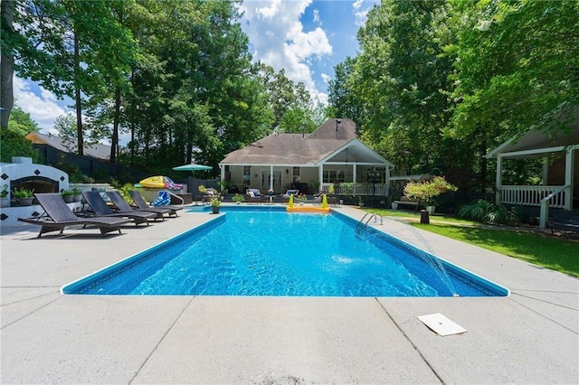 outdoor pool featuring an outbuilding, a patio, and fence