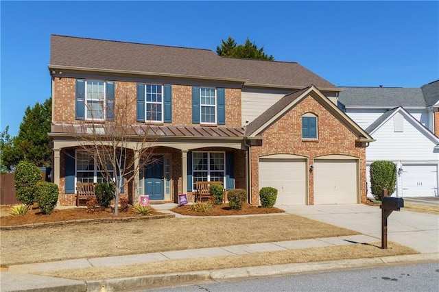 view of front of house featuring covered porch, brick siding, driveway, and an attached garage