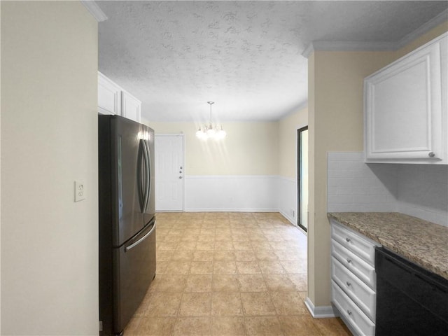 kitchen with backsplash, light tile patterned floors, stainless steel refrigerator, a textured ceiling, and white cabinetry