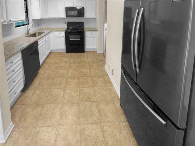 kitchen featuring sink, light tile patterned floors, and black appliances