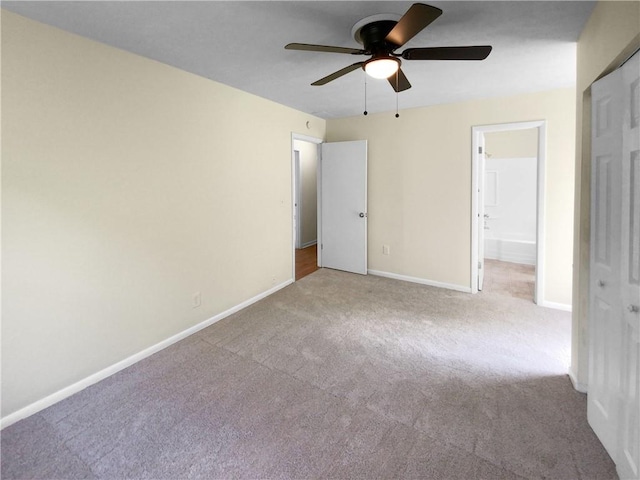 carpeted spare room with ceiling fan