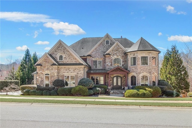 view of front of house with brick siding and french doors