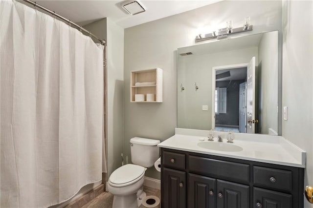 bathroom featuring vanity, a shower with shower curtain, and toilet