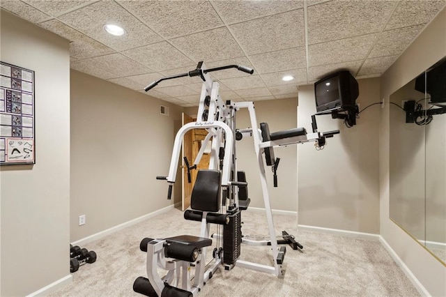 exercise area featuring carpet and a drop ceiling