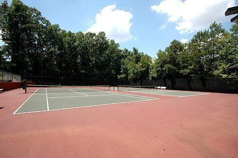 view of tennis court with basketball hoop