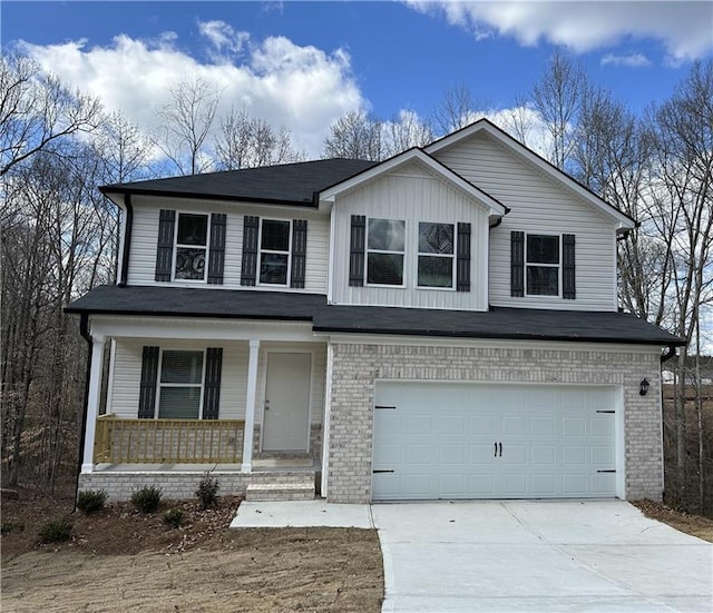 view of front of house with a porch, a garage, concrete driveway, and brick siding