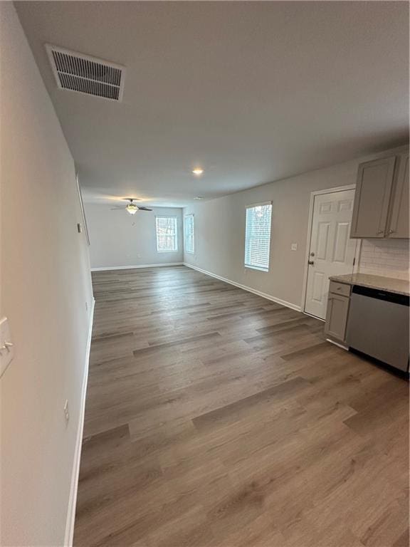 unfurnished living room with baseboards, light wood-style flooring, a ceiling fan, and recessed lighting