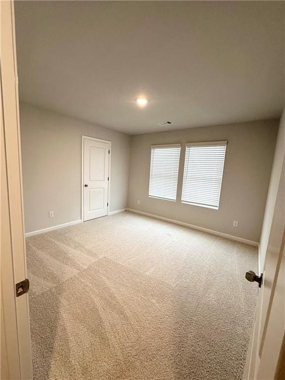 empty room featuring baseboards, carpet flooring, and recessed lighting