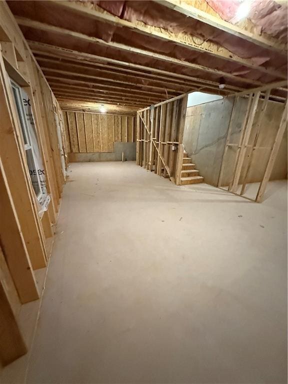 unfinished below grade area featuring stairway