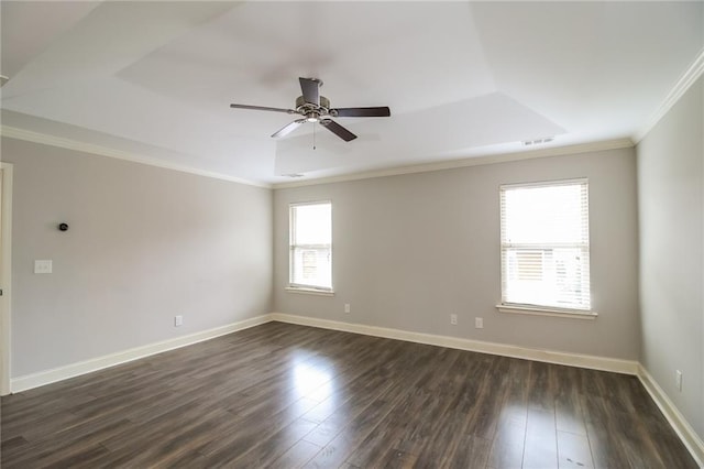 spare room featuring dark wood-style flooring, ornamental molding, and ceiling fan