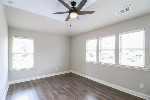 empty room featuring visible vents, baseboards, and plenty of natural light