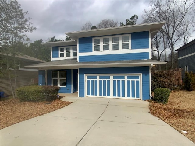 view of front of home with concrete driveway and a garage
