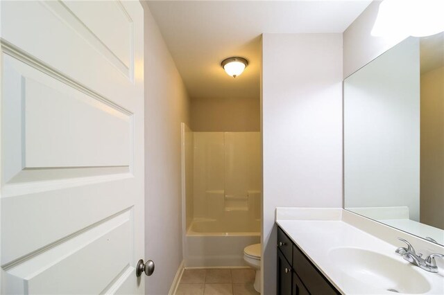 bathroom featuring toilet, tile patterned floors, vanity, and shower / tub combination