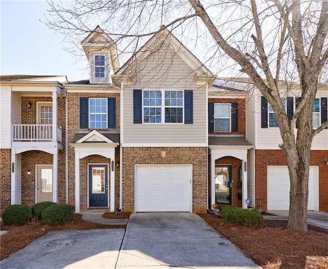 multi unit property with brick siding, concrete driveway, and an attached garage