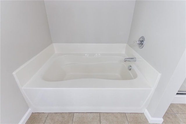 bathroom featuring tile patterned floors and a bath