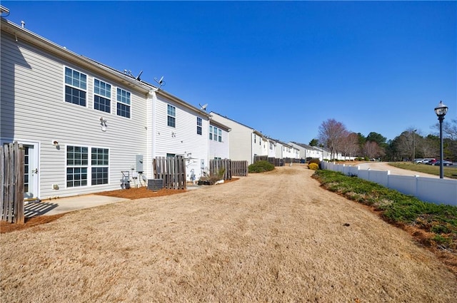 back of property with a patio area, a residential view, and fence