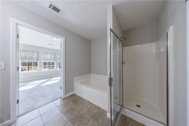 full bathroom with visible vents, a bath, a shower stall, and tile patterned flooring