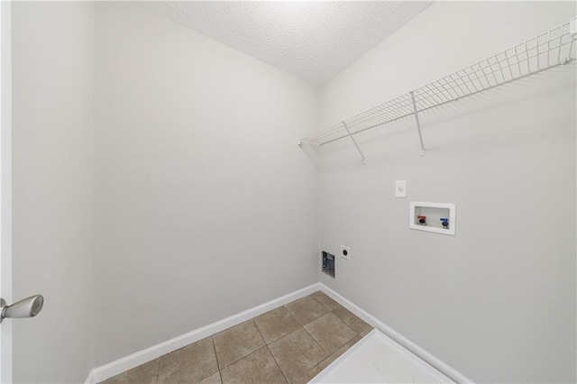 laundry area featuring baseboards, washer hookup, laundry area, electric dryer hookup, and a textured ceiling