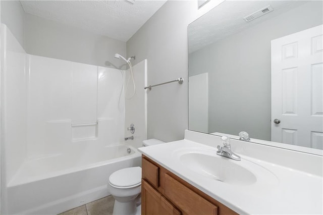 full bath featuring vanity, visible vents, a textured ceiling, shower / tub combination, and toilet