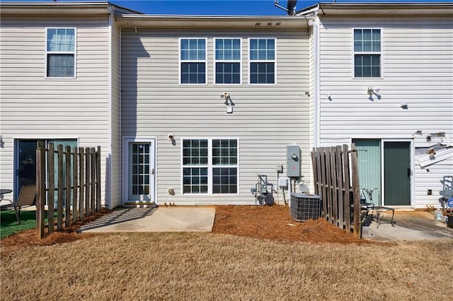 back of house featuring a patio area, central AC unit, a yard, and fence