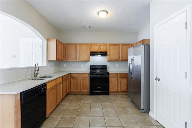 kitchen with black appliances, a sink, under cabinet range hood, light countertops, and light tile patterned floors