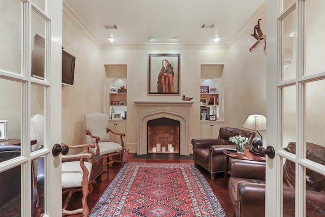 interior space with built in features, ornamental molding, dark wood-type flooring, and french doors