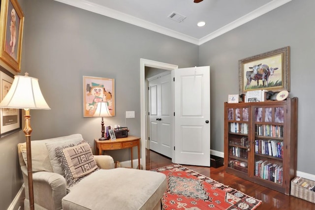 living area featuring crown molding and dark wood-type flooring