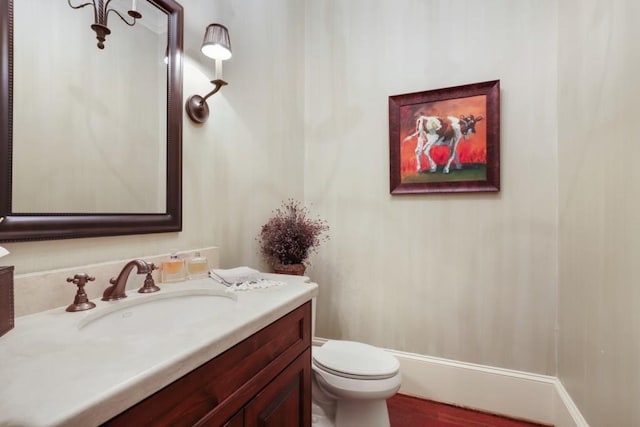 bathroom featuring toilet and vanity