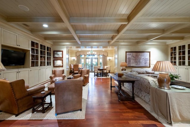 living room with a notable chandelier, light wood-type flooring, coffered ceiling, and beamed ceiling