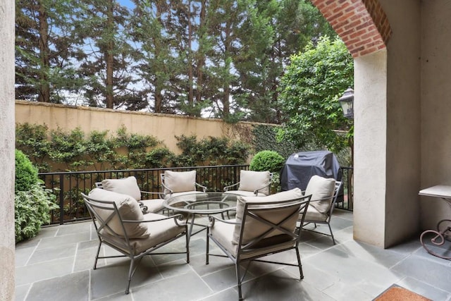 view of terrace featuring a grill and a fire pit