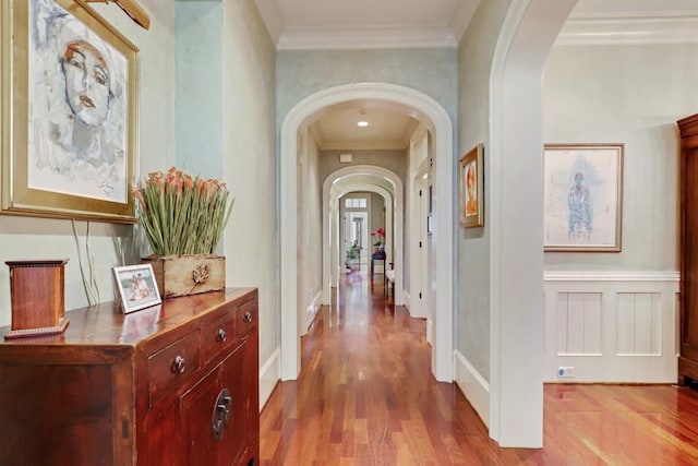 hall with crown molding and light hardwood / wood-style floors