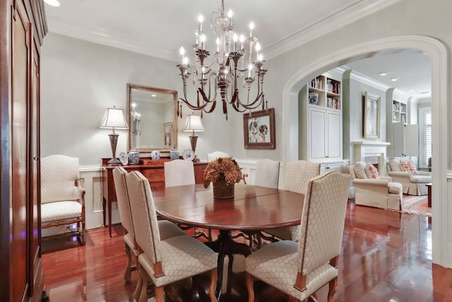 dining area with crown molding, dark hardwood / wood-style flooring, and a chandelier