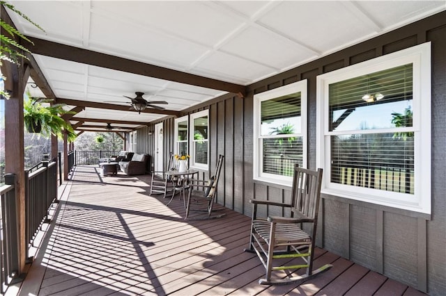 wooden deck with covered porch and a ceiling fan