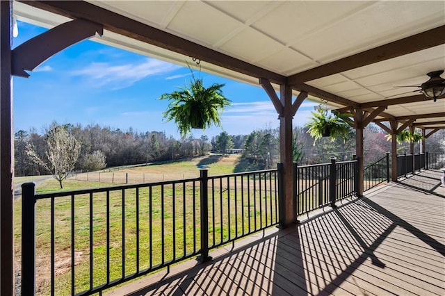 wooden deck featuring ceiling fan and a yard