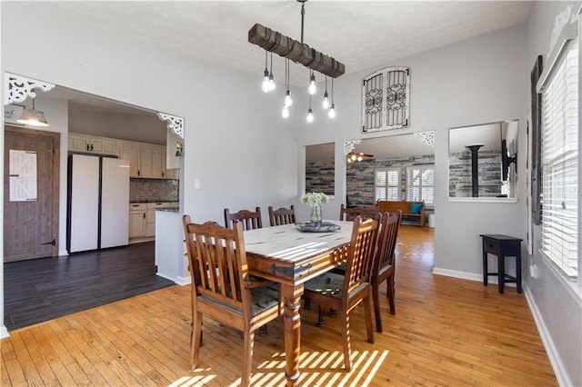 dining room with light wood-style flooring and baseboards