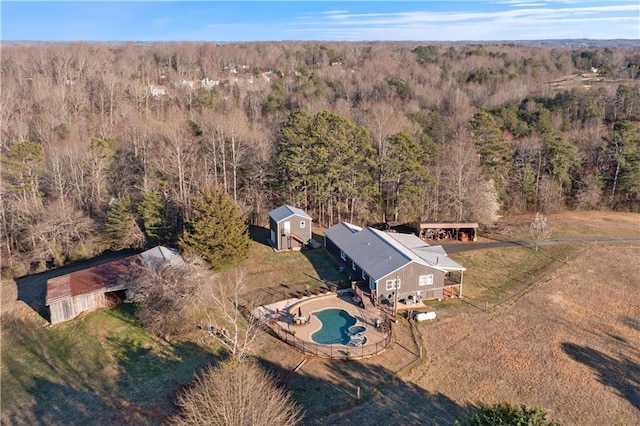 drone / aerial view featuring a wooded view