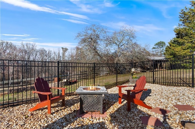 view of patio with fence and a fire pit