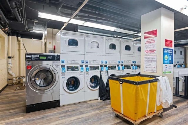 washroom featuring washer and clothes dryer, stacked washer / drying machine, and hardwood / wood-style floors