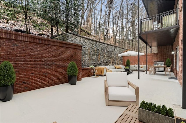 view of patio with an outdoor hangout area and a balcony