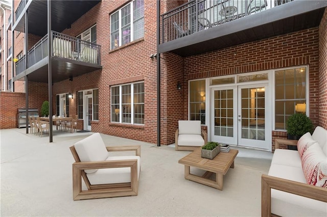 view of patio / terrace featuring french doors, a balcony, and outdoor lounge area